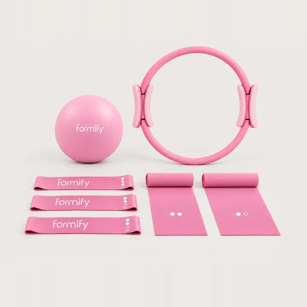 Core Essentials kit in pink: Pilates ring, ball, three loop bands and two flat bands (AI-generated draft)